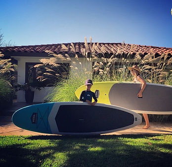 a person riding a surf board in the grass