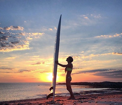 a man and a woman standing in front of a beach