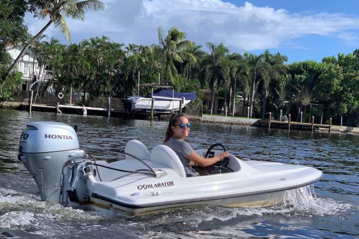 a man riding on the back of a boat in the water